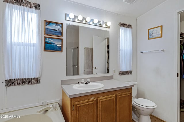 bathroom with toilet, a tub to relax in, an enclosed shower, and vanity