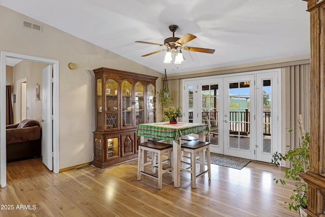 dining area featuring french doors, visible vents, light wood-style flooring, ceiling fan, and baseboards