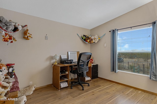 home office featuring light wood-type flooring and baseboards