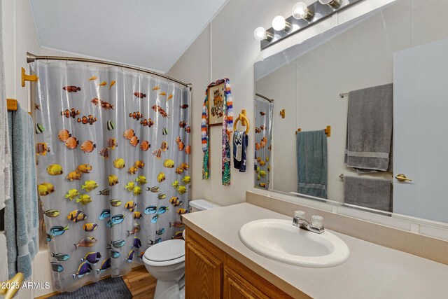 bathroom featuring wood finished floors, vanity, toilet, and shower / bathtub combination with curtain