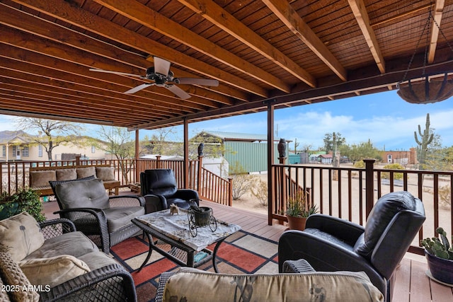 wooden terrace featuring an outdoor living space and a ceiling fan