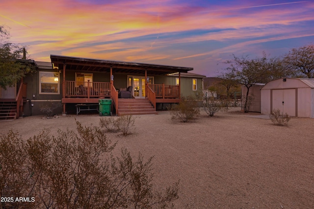 view of front of property with an outdoor structure and a shed