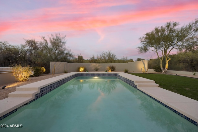 view of pool at dusk