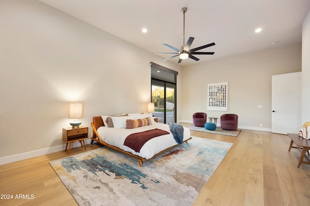 bedroom with light hardwood / wood-style floors and ceiling fan