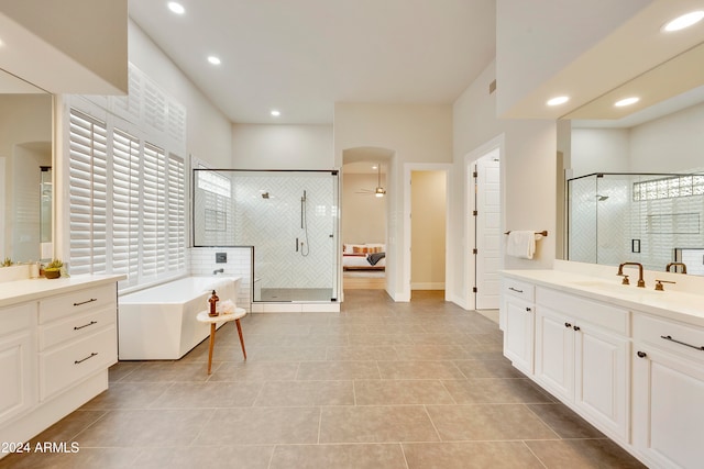 bathroom featuring vanity, tile patterned floors, and plus walk in shower