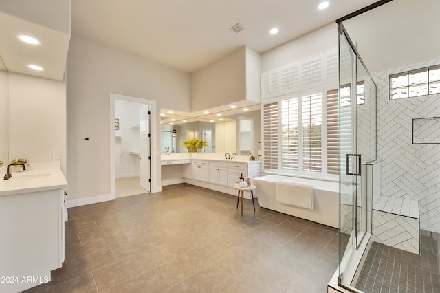 bathroom featuring vanity, tile patterned floors, and separate shower and tub