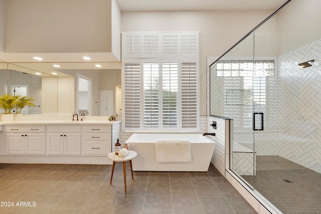 bathroom featuring tile patterned flooring, a wealth of natural light, and vanity