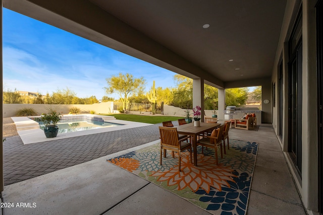 view of patio with a hot tub and a grill