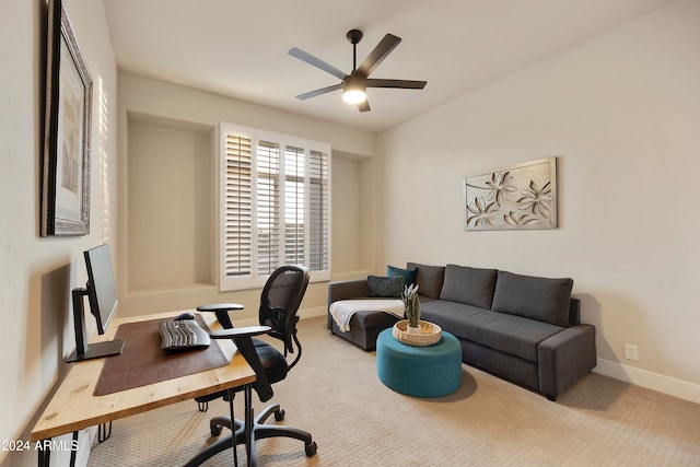 carpeted office space with ceiling fan