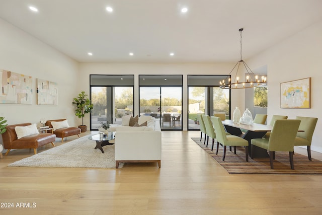 living room featuring light hardwood / wood-style flooring and a notable chandelier