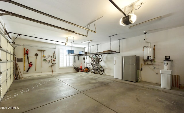 garage with a garage door opener, stainless steel refrigerator, and water heater