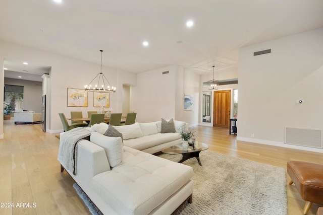 living room featuring light hardwood / wood-style floors and an inviting chandelier