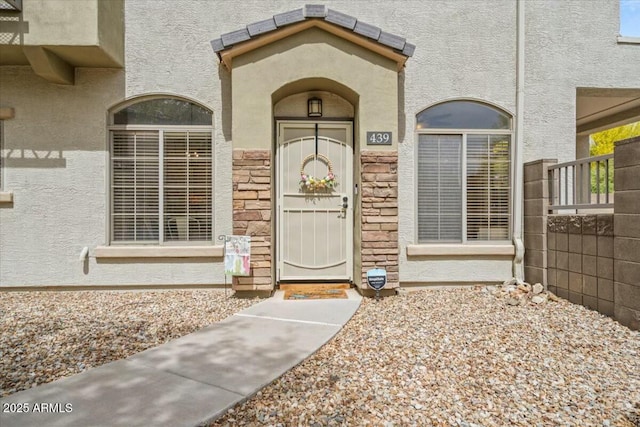 view of exterior entry with stucco siding