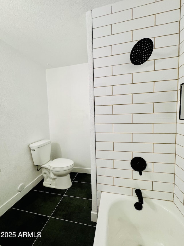 full bath with tile patterned flooring, toilet, a textured ceiling, baseboards, and bathtub / shower combination