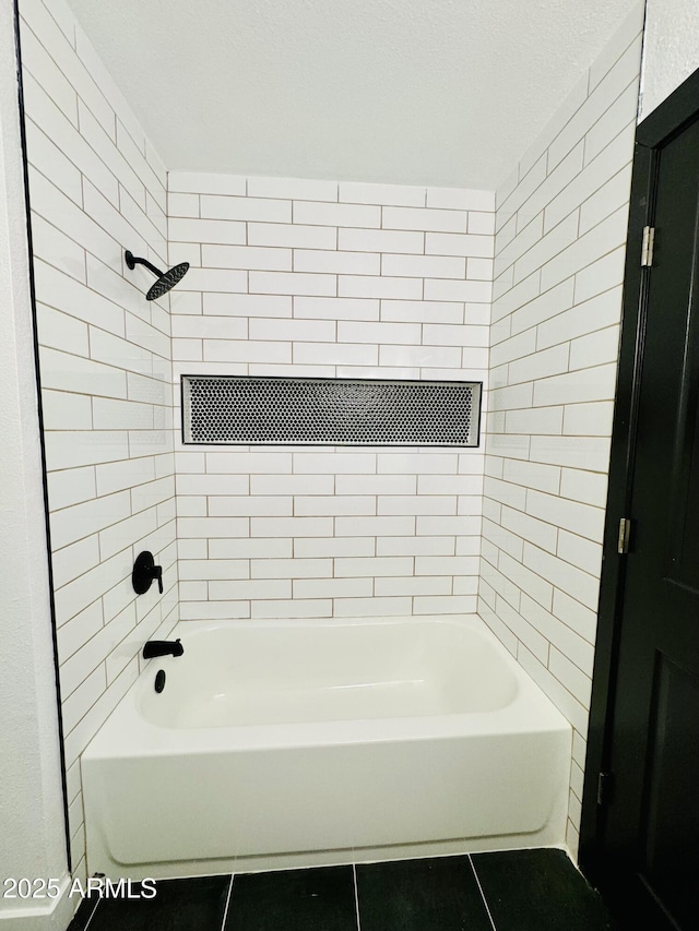 bathroom featuring tile patterned flooring and shower / bath combination
