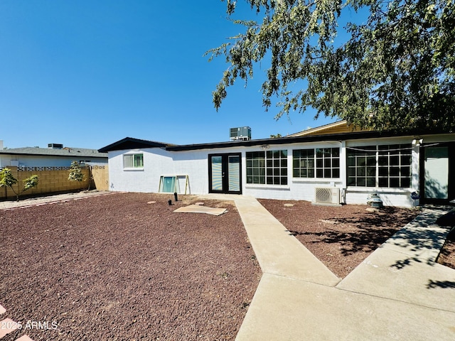 back of house with fence, french doors, and a sunroom