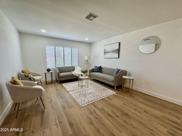 living area with wood finished floors, baseboards, and recessed lighting