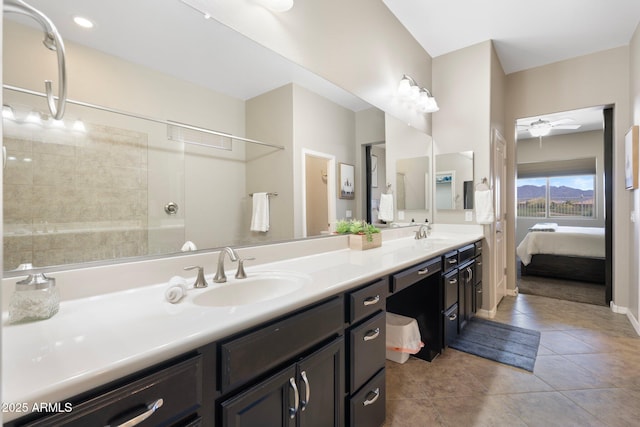ensuite bathroom featuring a sink, tile patterned flooring, ensuite bath, and double vanity