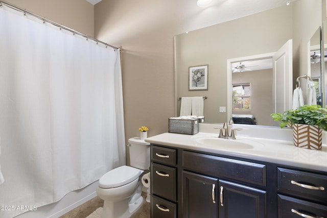 ensuite bathroom featuring vanity, tile patterned flooring, shower / bath combination with curtain, toilet, and ensuite bath