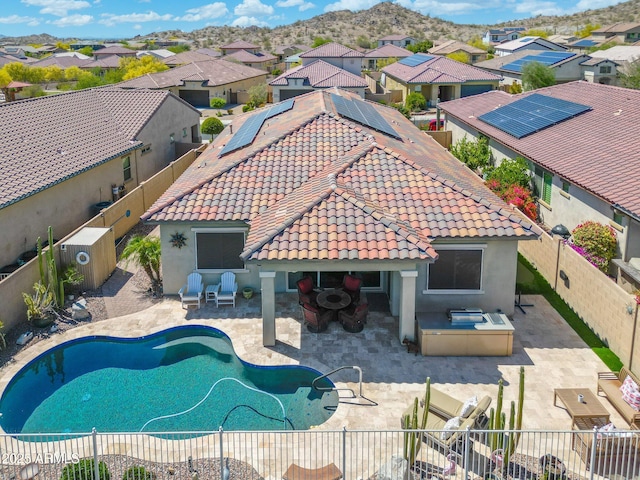 view of swimming pool with a fenced backyard, a patio area, exterior kitchen, and a residential view