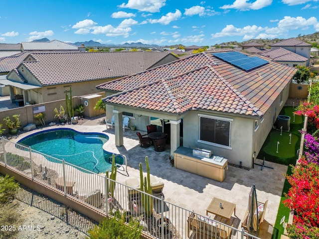 view of pool with area for grilling, a fenced backyard, a fenced in pool, central AC unit, and a patio