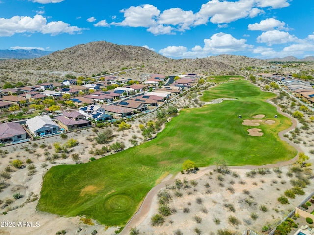drone / aerial view with view of golf course, a mountain view, and a residential view