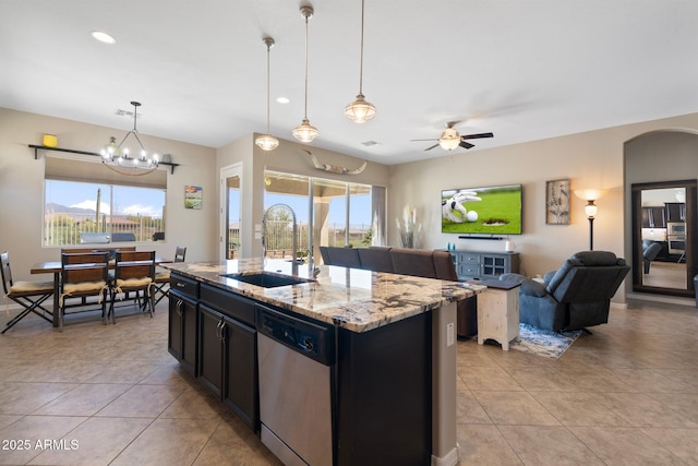 kitchen featuring a sink, a healthy amount of sunlight, open floor plan, and dishwasher