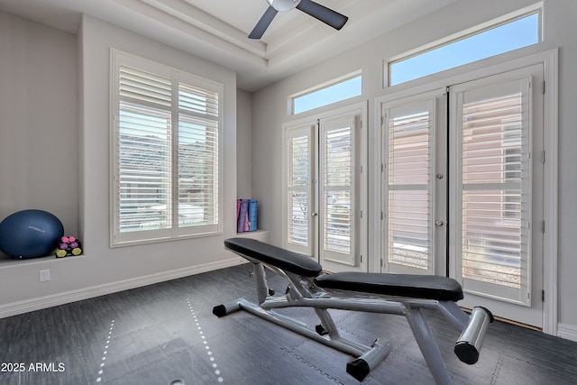 workout area with a wealth of natural light, baseboards, and ceiling fan