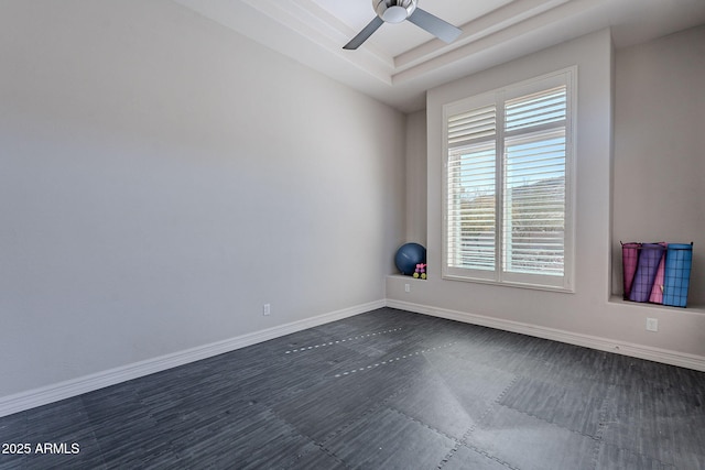 unfurnished room featuring baseboards and ceiling fan