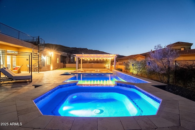 view of pool featuring a patio, a pool with connected hot tub, stairs, and a pergola