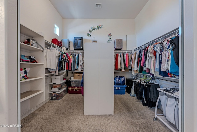 walk in closet with visible vents and carpet floors