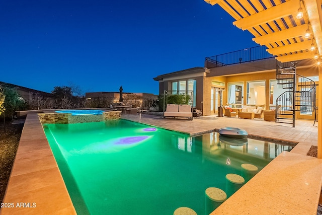 pool at twilight with a pool with connected hot tub, fence, stairway, outdoor lounge area, and a patio