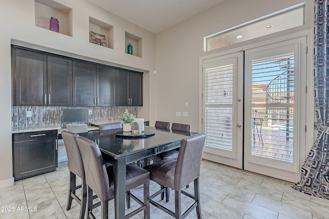 dining space with light tile patterned floors and french doors