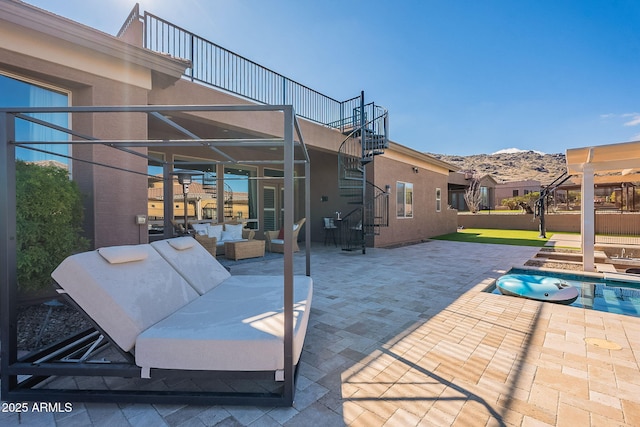 view of patio featuring an outdoor living space, a mountain view, stairs, and a fenced in pool