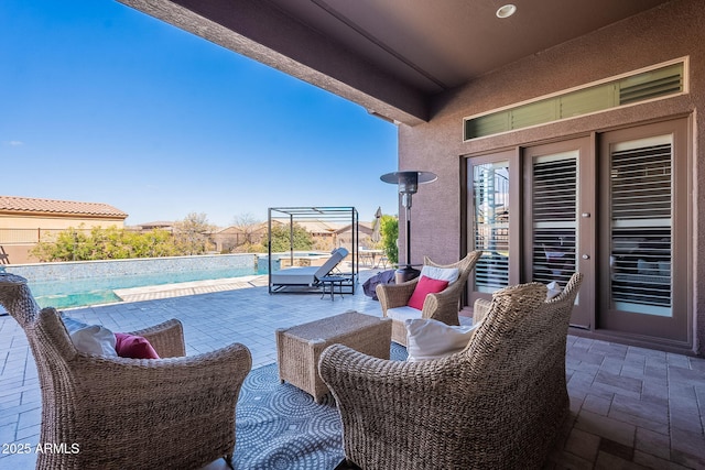 view of patio / terrace with a fenced in pool and an outdoor hangout area