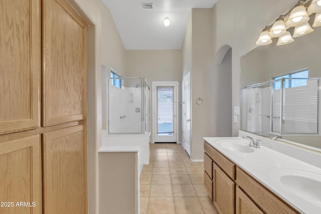 bathroom featuring tile patterned flooring, a wealth of natural light, and walk in shower