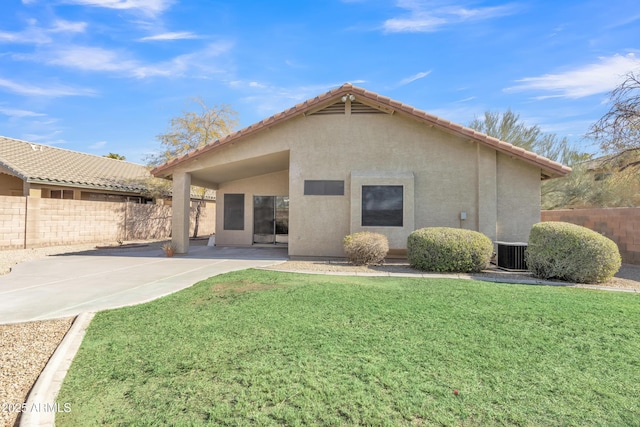 back of property with a lawn, a patio, and central air condition unit