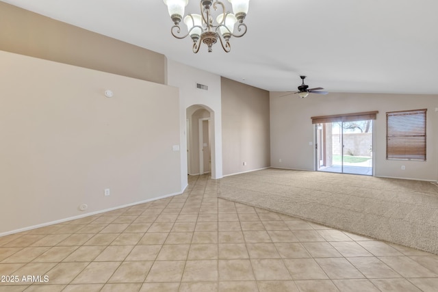 carpeted empty room with ceiling fan with notable chandelier and vaulted ceiling