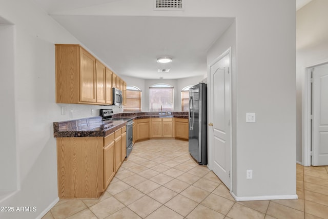 kitchen featuring stainless steel appliances, light tile patterned flooring, sink, and light brown cabinets