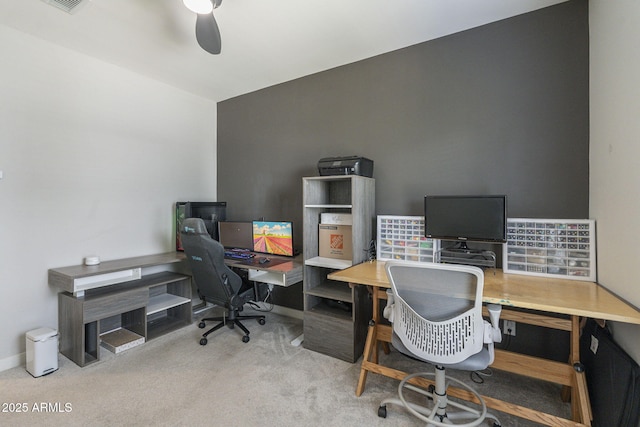 office space featuring light carpet and ceiling fan