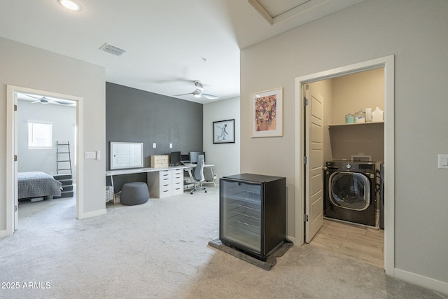 interior space with independent washer and dryer, light carpet, and wine cooler