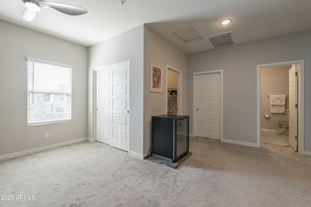 carpeted bedroom featuring ensuite bathroom and ceiling fan