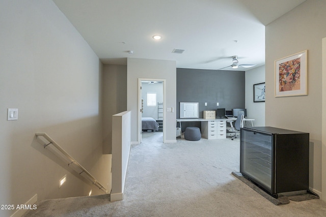 hallway featuring light colored carpet