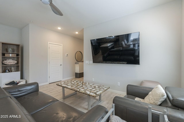 living room with ceiling fan and light hardwood / wood-style flooring