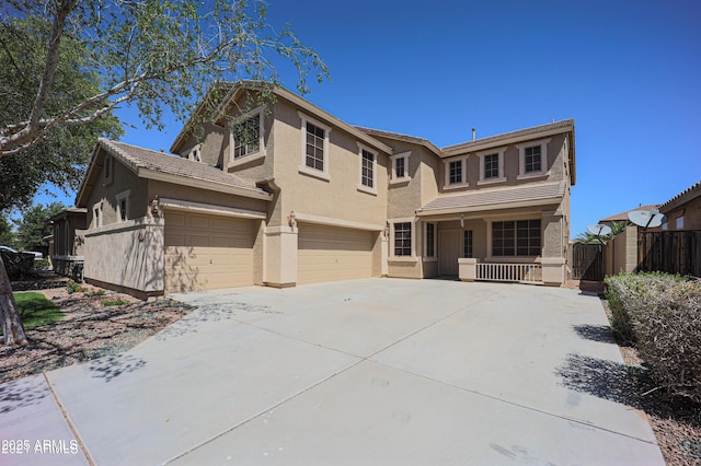 view of front of home with covered porch, concrete driveway, stucco siding, and an attached garage