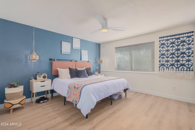 bedroom with light hardwood / wood-style flooring and ceiling fan