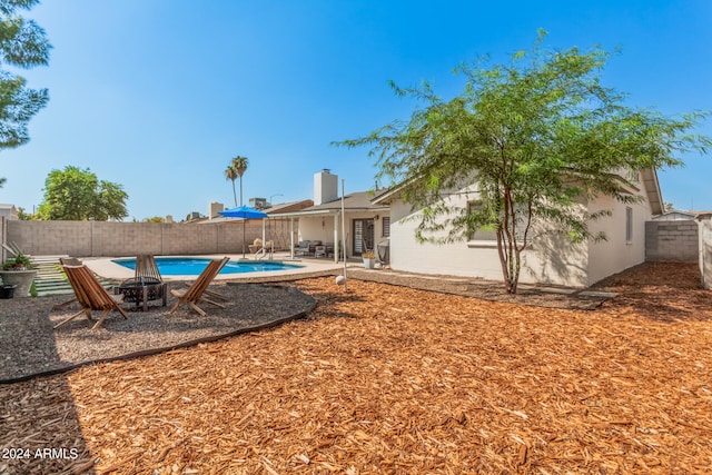 view of yard with a fenced in pool and a patio