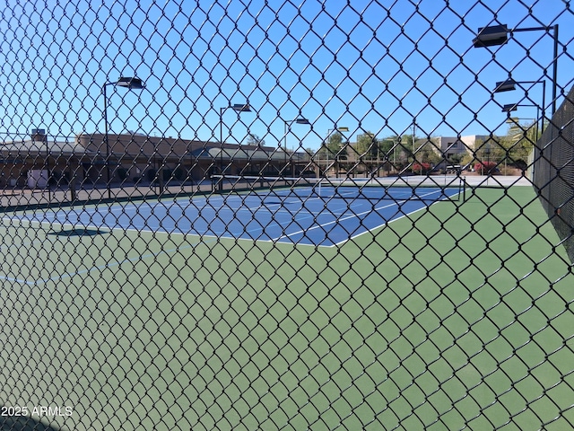 view of tennis court with fence