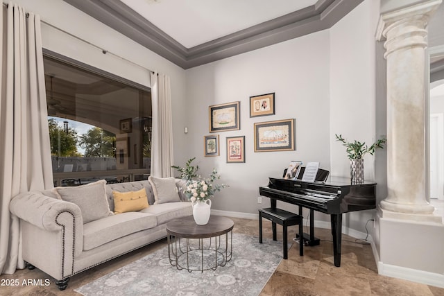 living area featuring decorative columns and baseboards