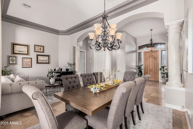 dining area featuring arched walkways, visible vents, a notable chandelier, and ornate columns